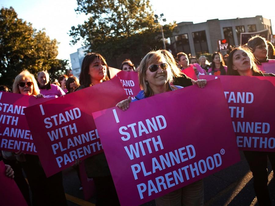 HEMPSTEAD, NY - OCTOBER 16:  Women protest for continued funding of Planned Parenthood outside Hofstra University prior to the second presidential debate on October 16, 2012 in Hempstead, New York. U.S. President Barack Obama and Republican presidential candidate Mitt Romney will debate in a town hall style meeting this evening at the university.  (Photo by Andrew Burton/Getty Images)