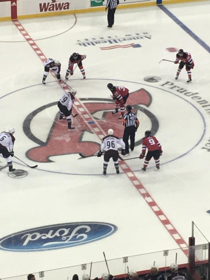 The Devils line up for the opening puck drop of the season.