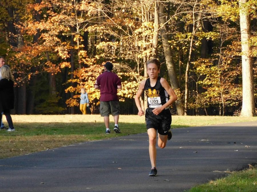 Collin Clinton crosses the finish line to get first overall at Conference Championships.  Photo Courtesy: Julie Bramley.
