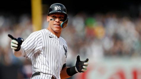 Aaron Judge points to his teammates after hitting a homerun.