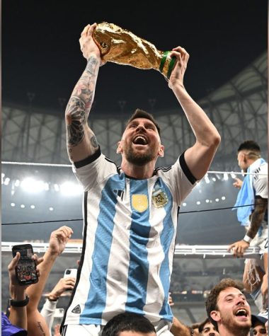 Messi holding up the World Cup trophy after defeating France