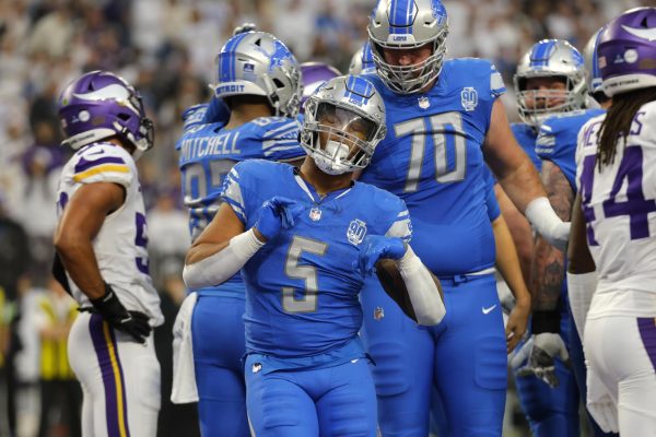 Lions running back David Montgomery celebrates after scoring a touchdown during a game in Minnesota vs. the Vikings.