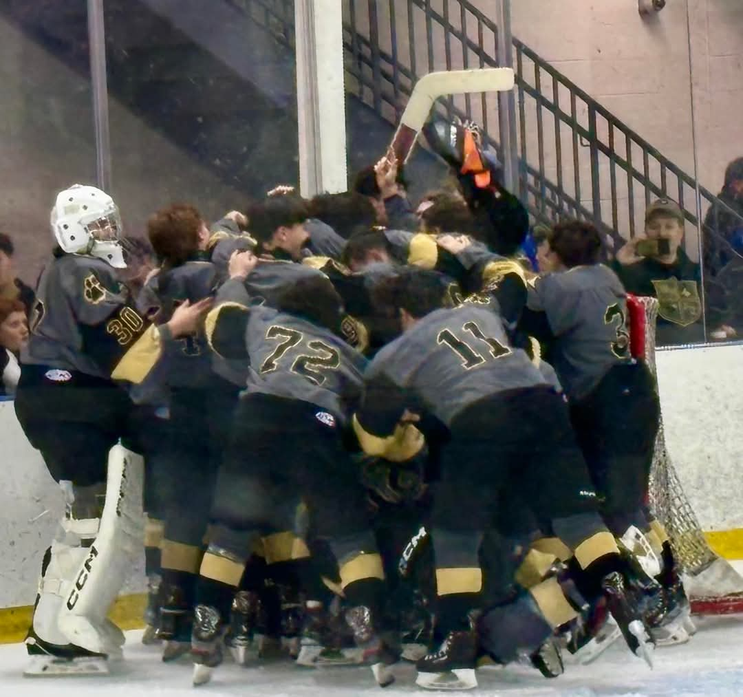 The team hoists their trophy after their victory that earned them the Big North Silver Cup.